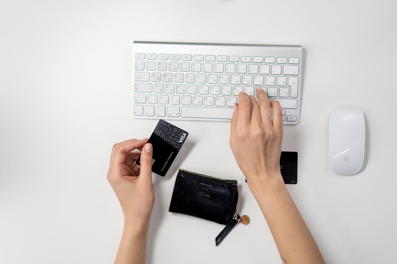 E-commerce setup featuring a keyboard, card, and wallet, ideal for online shopping concepts.